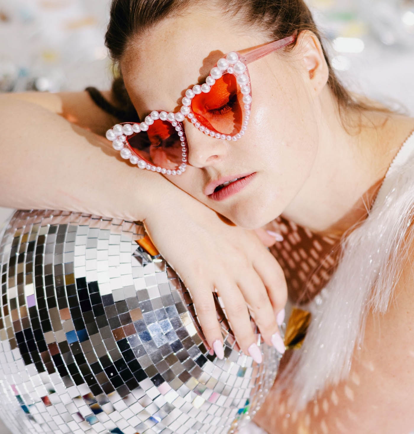 Model posing with disco ball